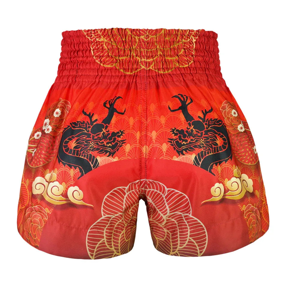 Red Muay Thai shorts with black dragon design on a white background