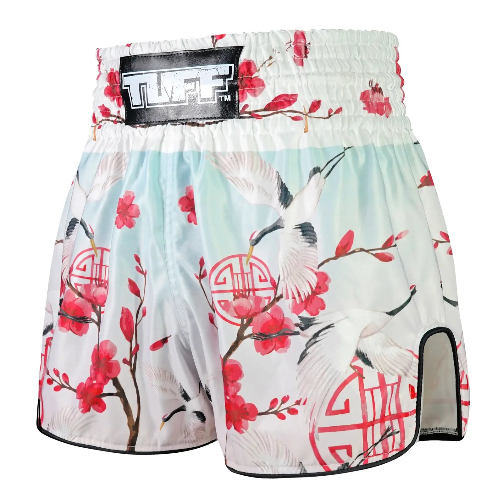 Muay Thai shorts with floral and bird design on a white background, featuring the brand 'TUFF'.