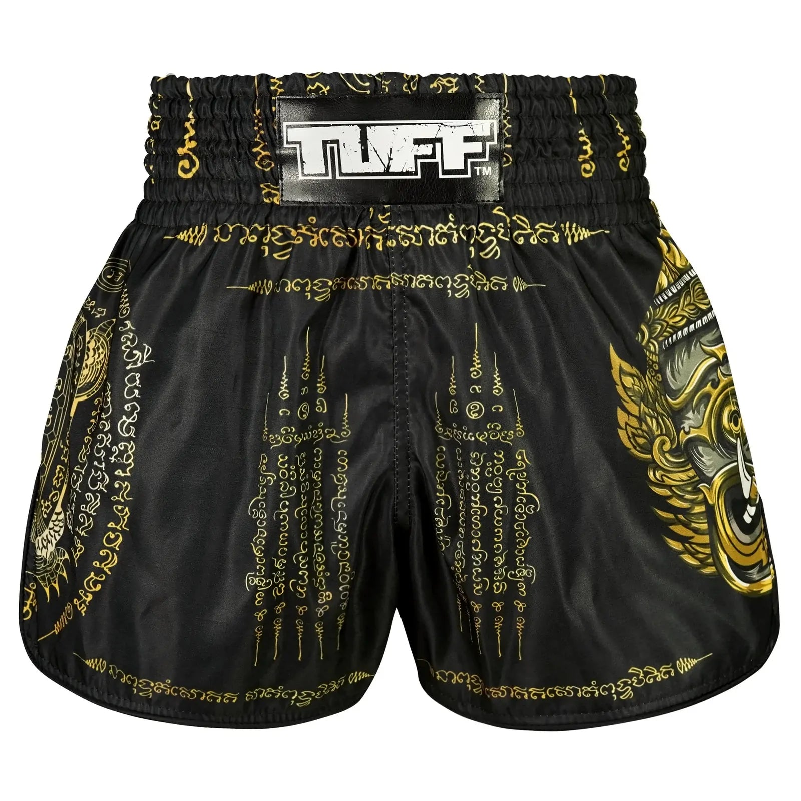 Black and gold patterned Muay Thai shorts with TUFF branding on a white background
