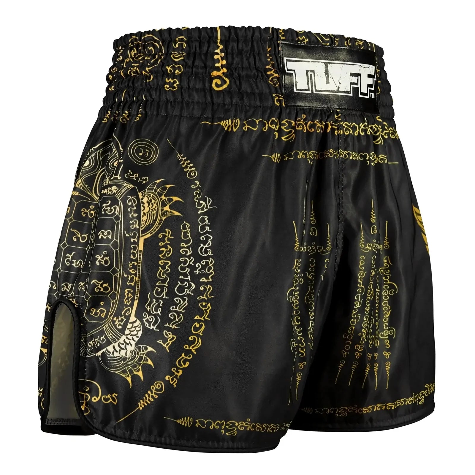 Black and gold patterned Muay Thai shorts with a brand logo on a white background