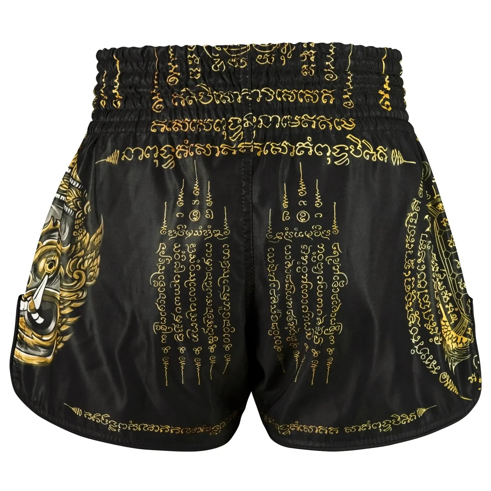 Black Muay Thai shorts with gold embroidery and patterns on a white background