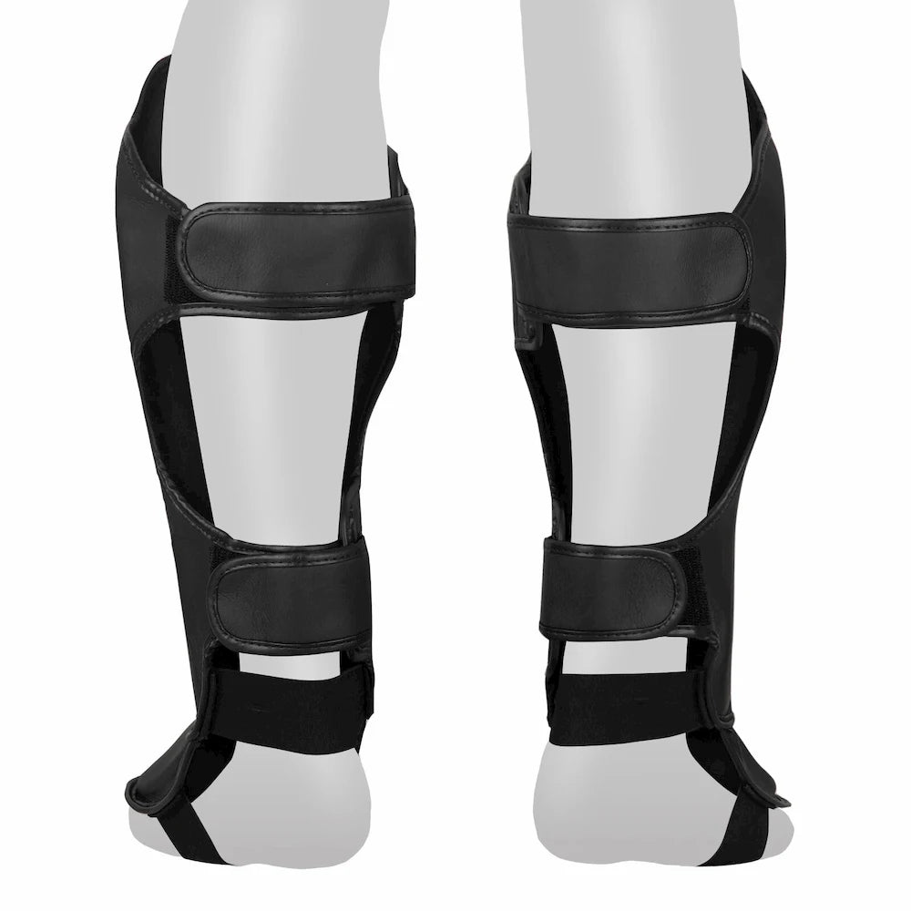 Rear profile of black Tuff Sport shin guards on a white background