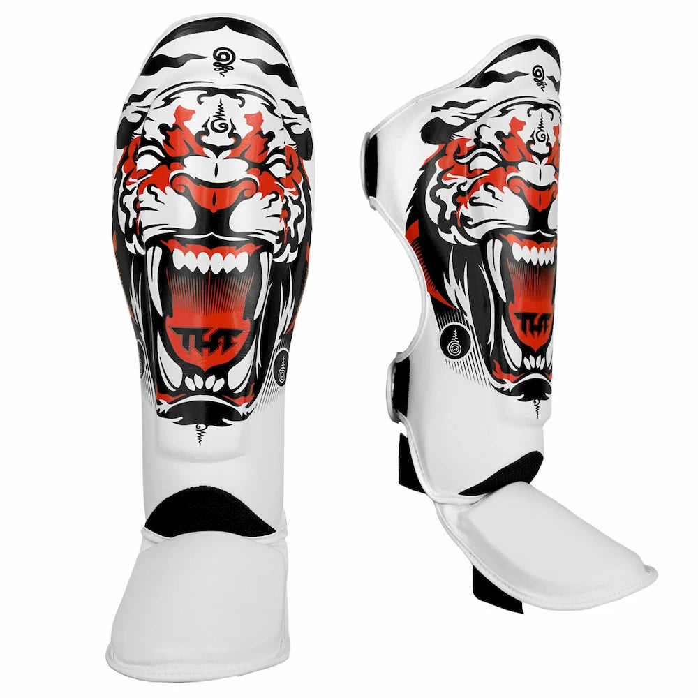 White Tuff Sport shin guards with tiger design on a white background