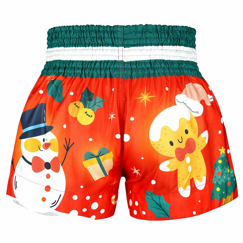 Christmas-themed Muay Thai shorts with snowman and gingerbread man design on a red background