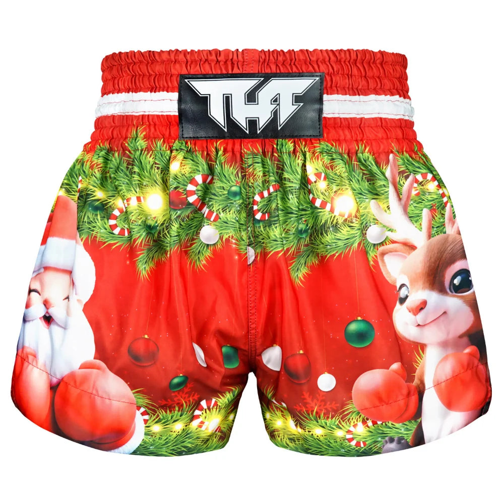 Red Muay Thai boxing shorts with Christmas-themed design featuring Santa Claus and reindeer on a white background.
