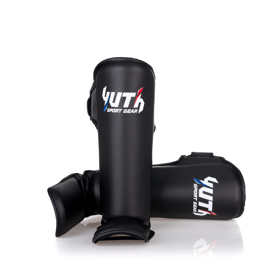 Black shin guards with Yuth Sport Gear branding on a white background