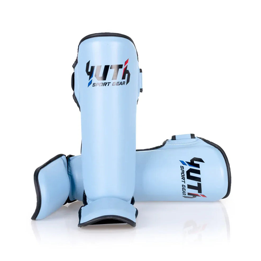 Light blue shin guards with 'YUTH SPORT GEAR' branding on a white background