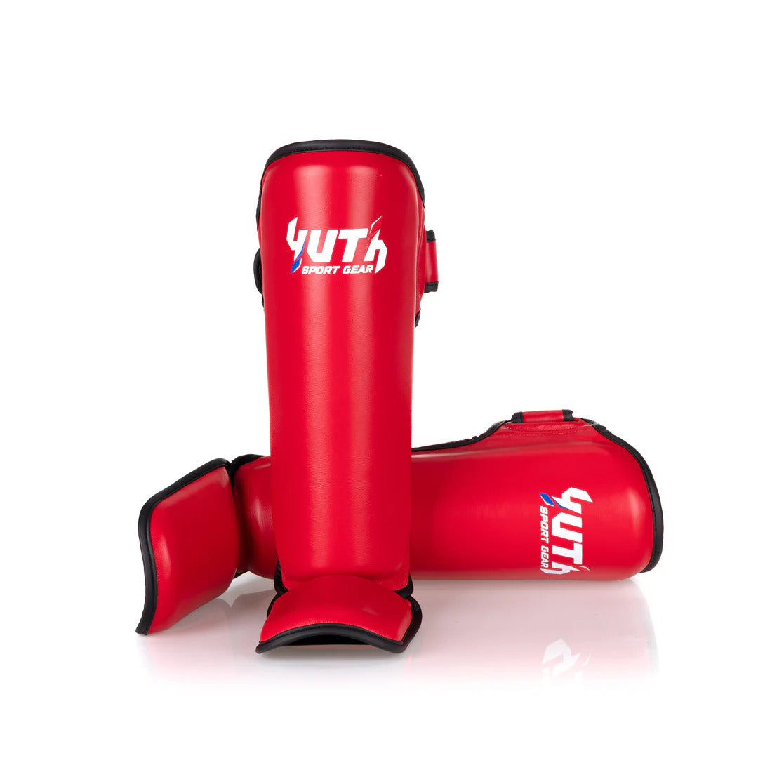 Red shin guards with 'Yuth' branding on a white background