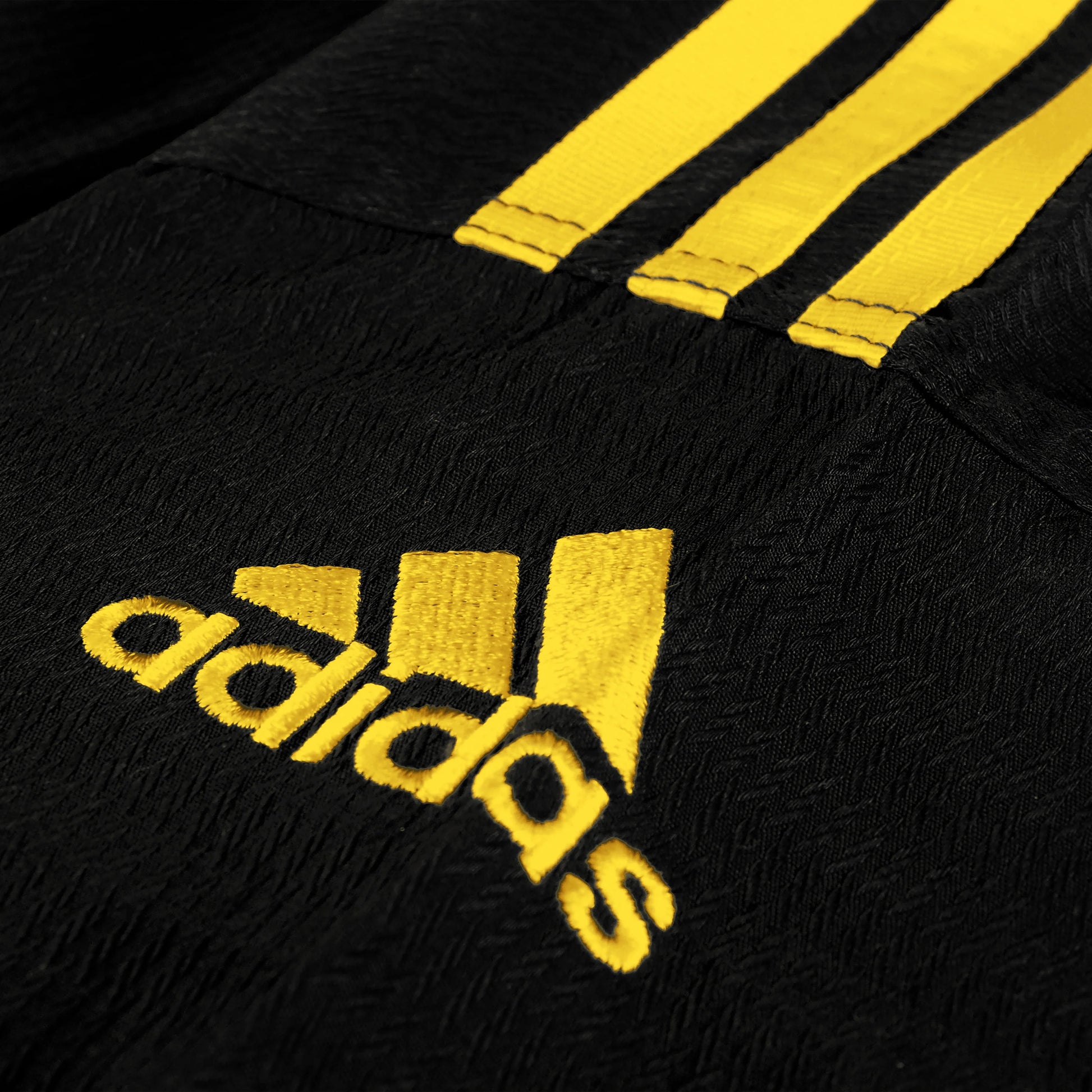 Black sports outfit with yellow stripes and Adidas logo