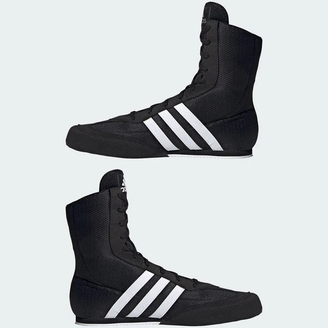 Black boxing shoes with white stripes on a light gray background