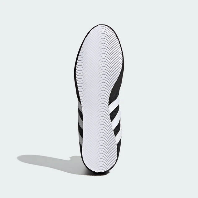 Black and white Adidas shoe sole on a light gray background