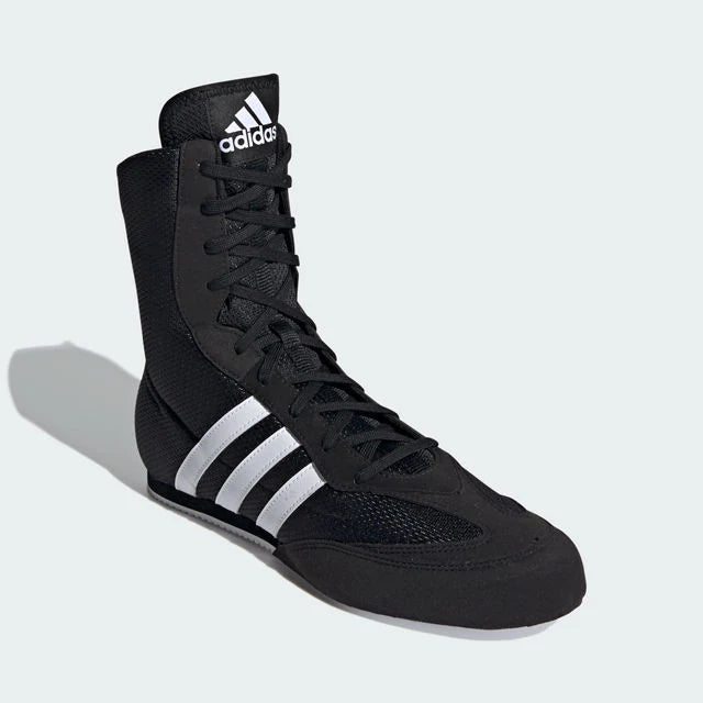 Black Adidas boxing shoes on a light gray background