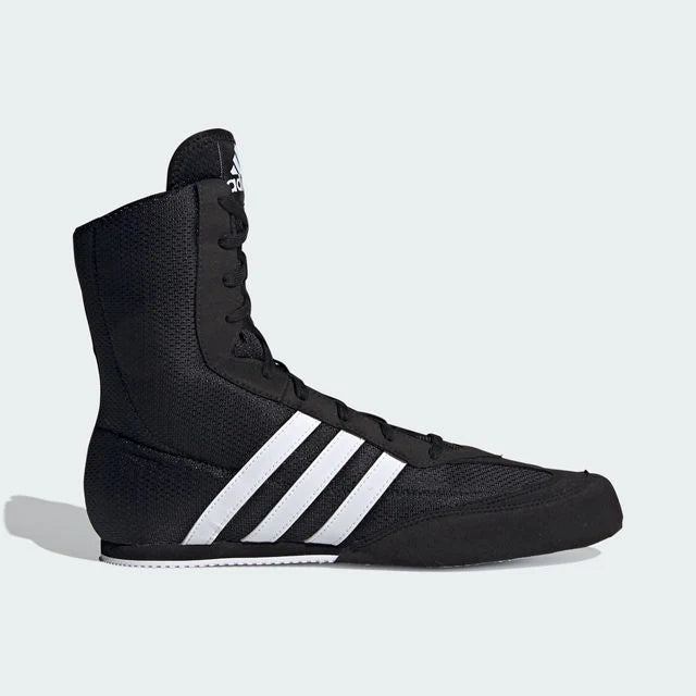 Black Adidas boxing boot with white stripes on a light gray background