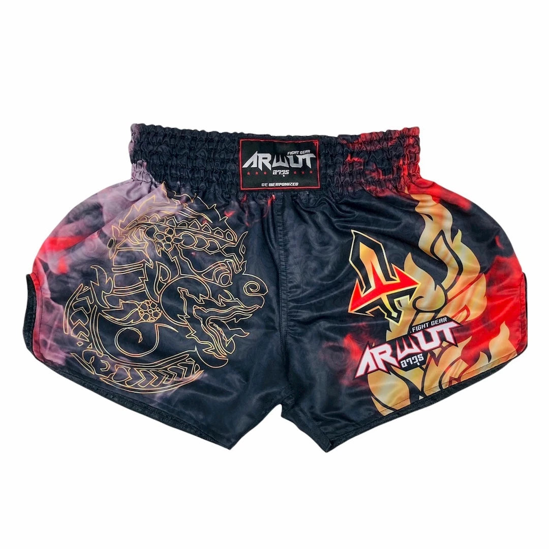 Pair of black Muay Thai shorts with dragon and flame designs on a white background