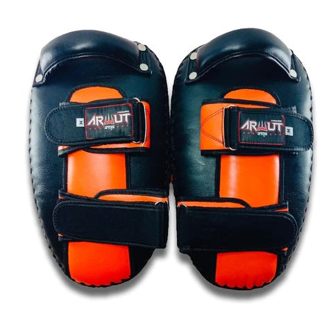 Pair of black and orange Muay Thai pads with 'Arwut' branding on a white background.