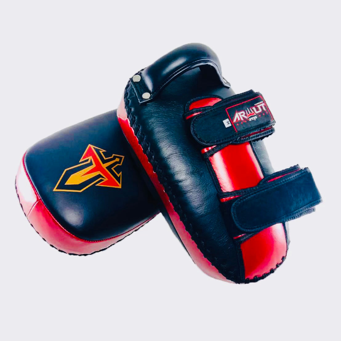Pair of black and red Muay Thai pads with visible branding on a light gray background