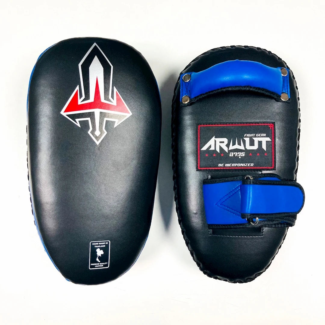 Pair of black and blue Muay Thai pads with visible branding on a white background