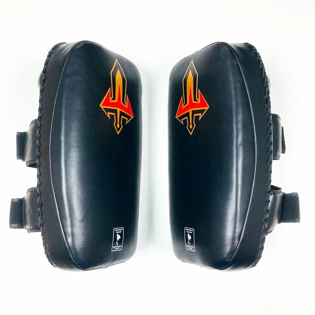 Pair of black Muay Thai pads with a red and yellow logo on a white background