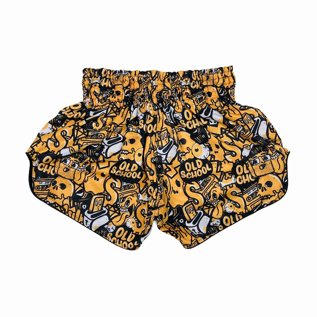 Yellow and black patterned Muay Thai shorts with 'Old School' text on a white background