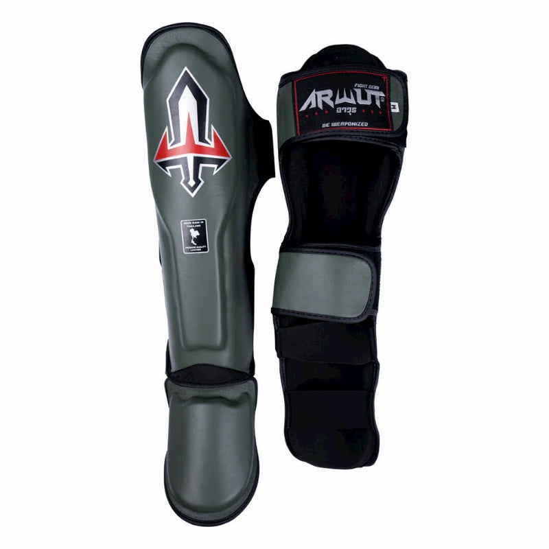 Pair of black and gray Arwut shin guards with visible branding on a white background