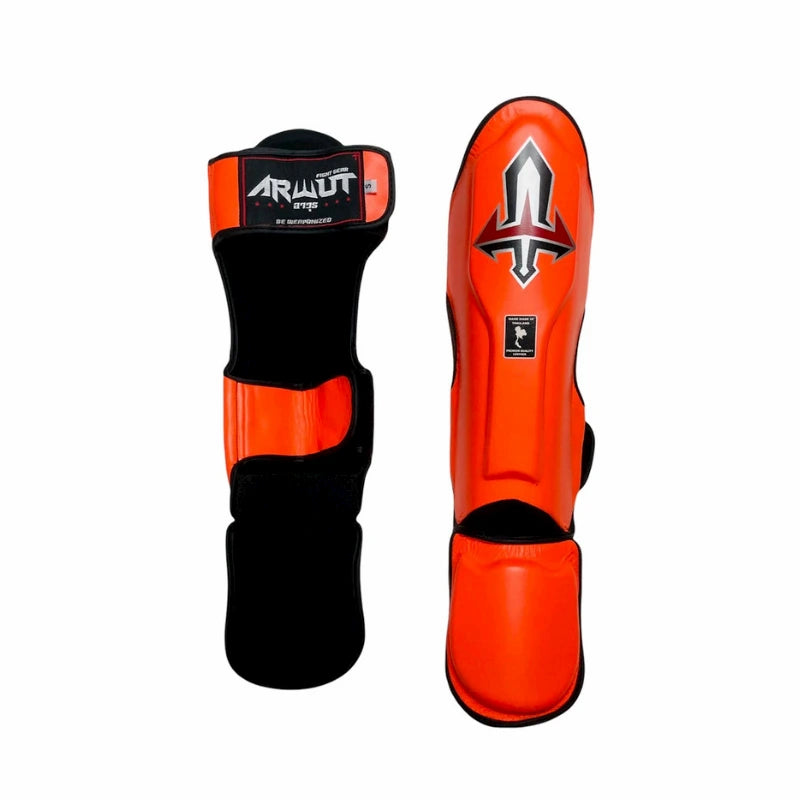 Orange and black Arwut shin guards with brand logo on a white background