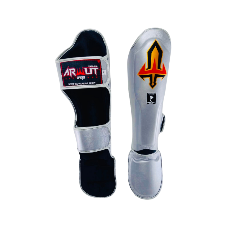 Pair of silver and black Arwut shin guards with brand logos on a white background