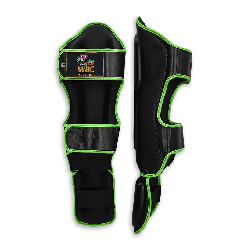 Black and green shin guards with WBC logo on a white background