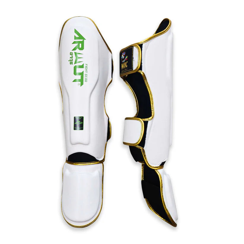 White shin guards with black and gold accents on a white background