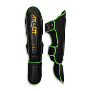 Black shin guards with green accents and 'Arwut' branding on a white background