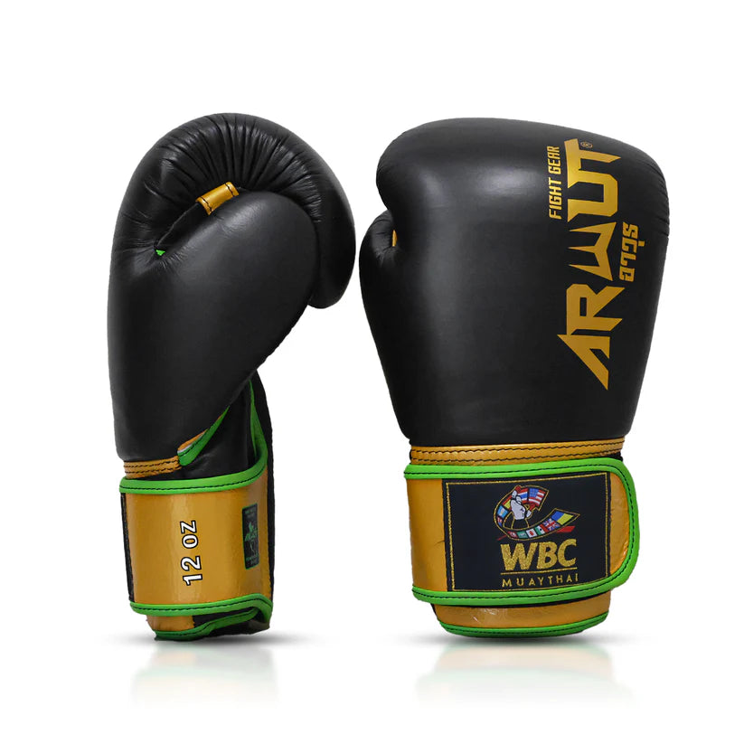 Black and gold boxing gloves with WBC Muay Thai logo on a white background