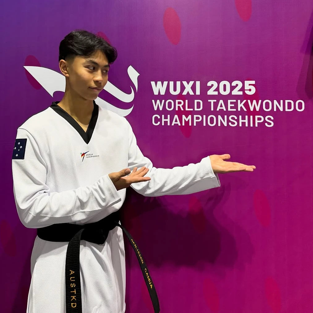 Person in a white martial arts uniform with a black belt against a purple background with 'Wuxi 2025 World Taekwondo Championships' text.