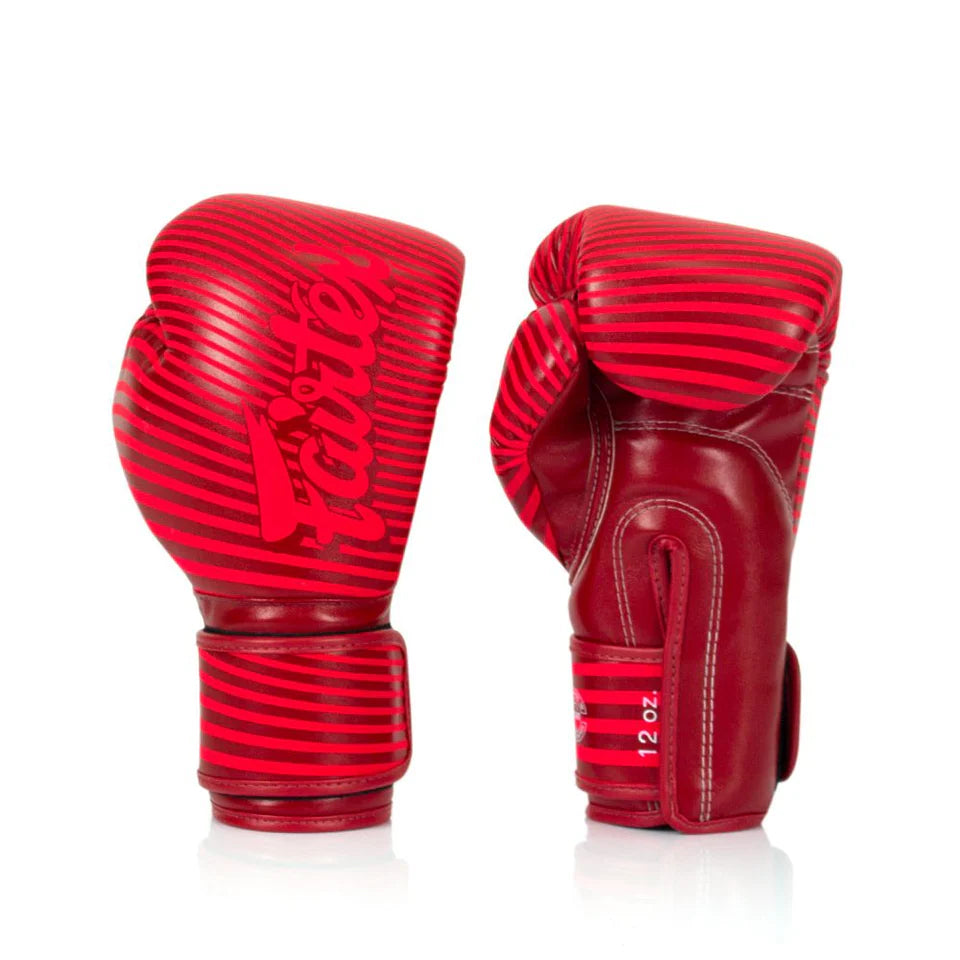 Red boxing gloves with 'Fairtex' branding on a white background