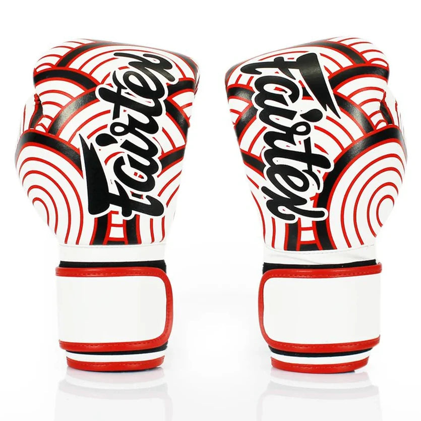 Pair of boxing gloves with red and black patterns on a white background
