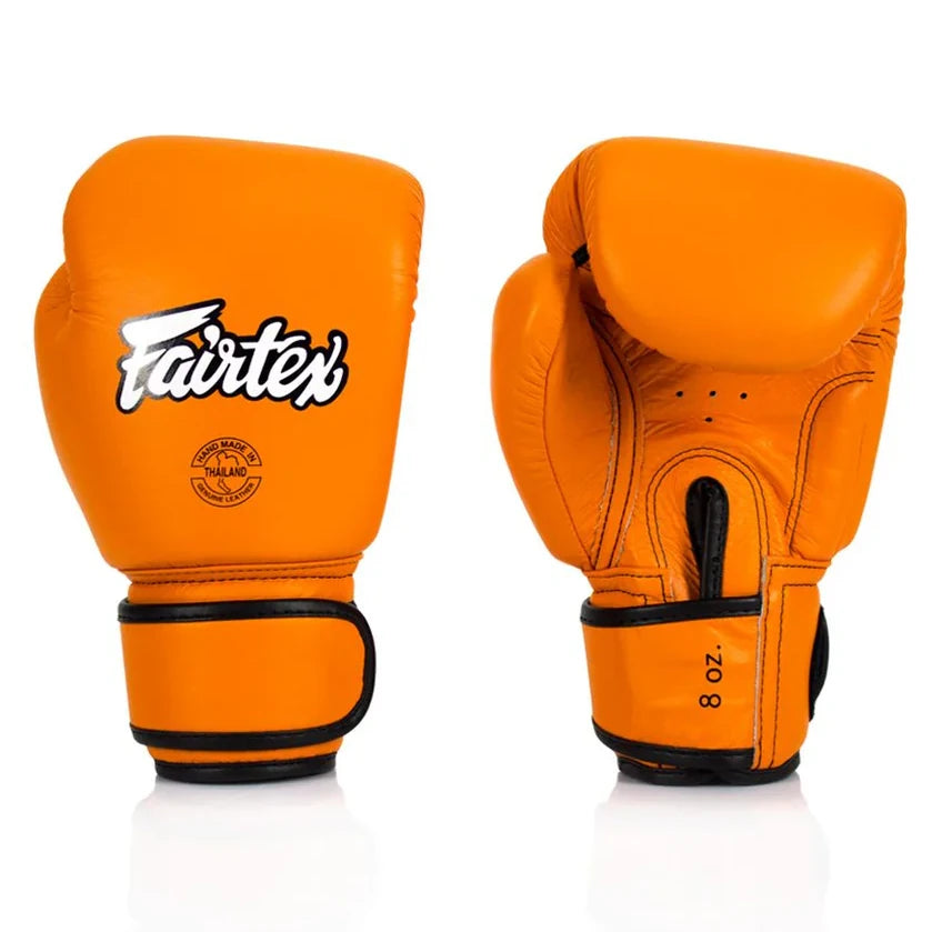 Orange boxing gloves with Fairtex logo on a white background
