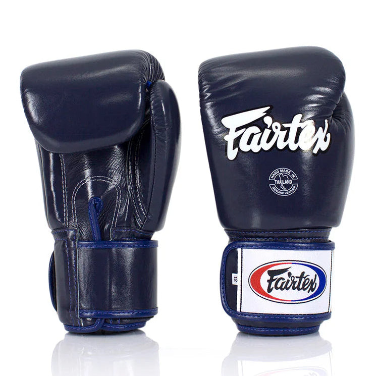 Pair of navy blue boxing gloves with Fairtex logo on a white background