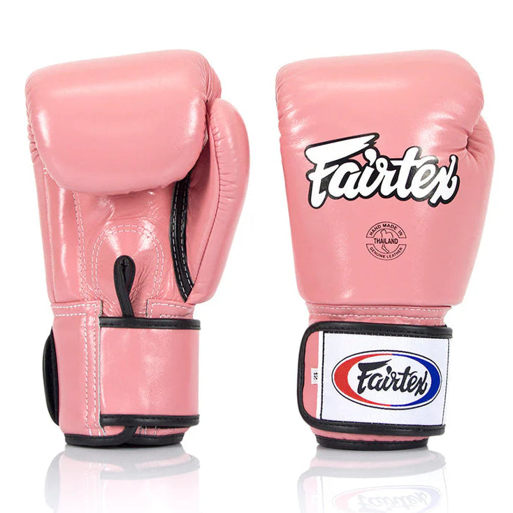 Pink boxing gloves with Fairtex logo on a white background