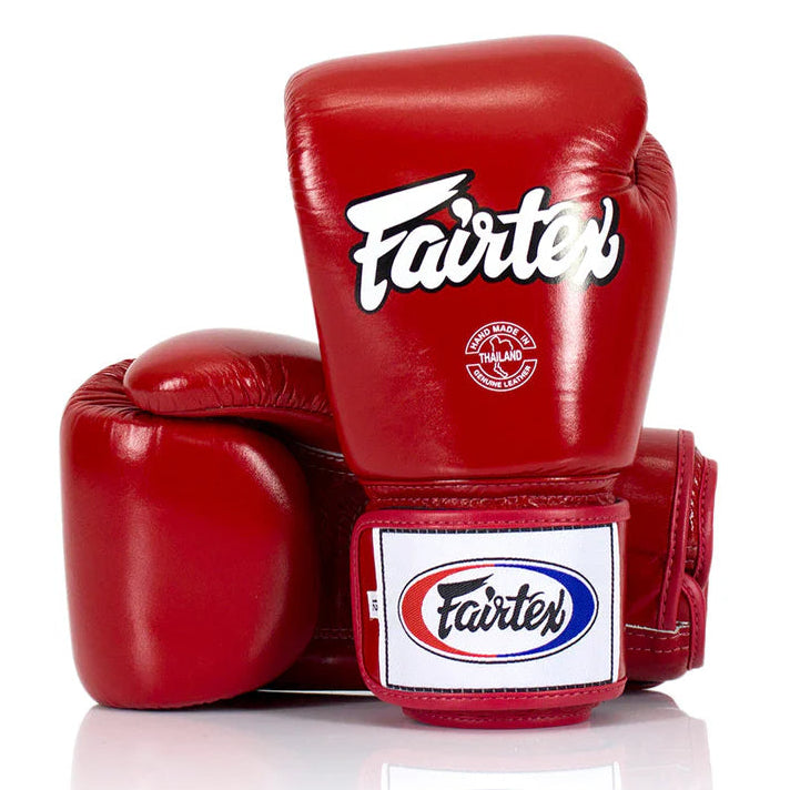 Red boxing gloves with Fairtex logo on a white background