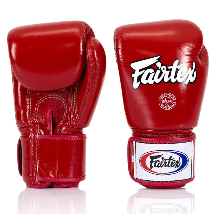 Red boxing gloves with Fairtex logo on a white background