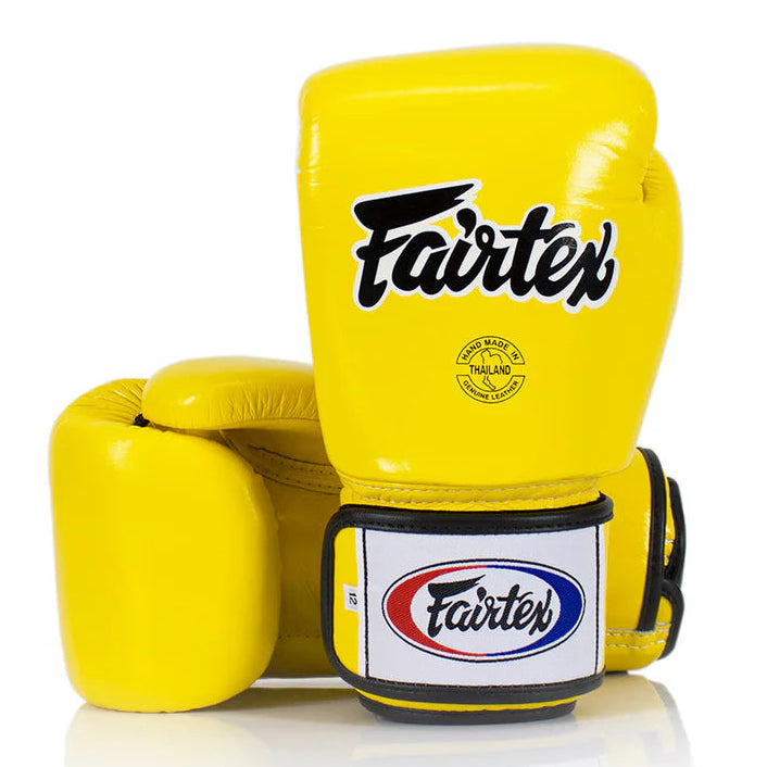 Yellow boxing glove with Fairtex branding on a white background