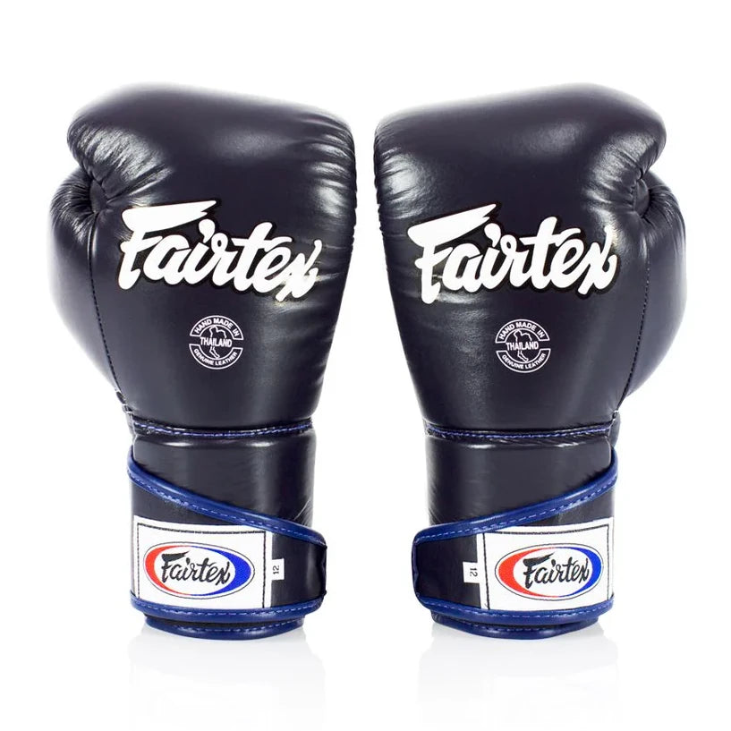 Pair of navy blue Fairtex boxing gloves on a white background