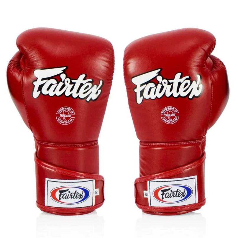 Red Fairtex boxing gloves on a white background
