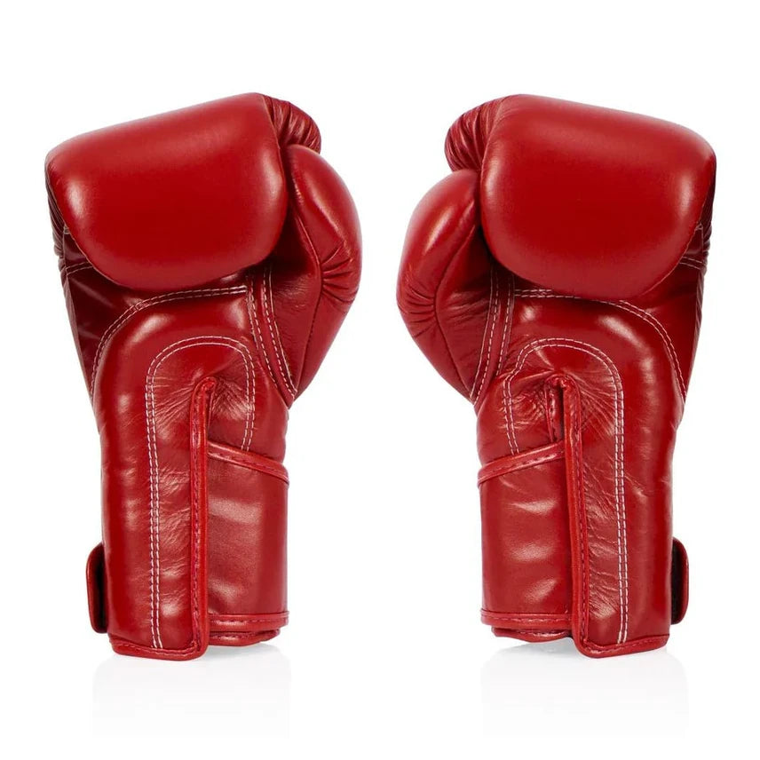 Pair of red boxing gloves on a white background