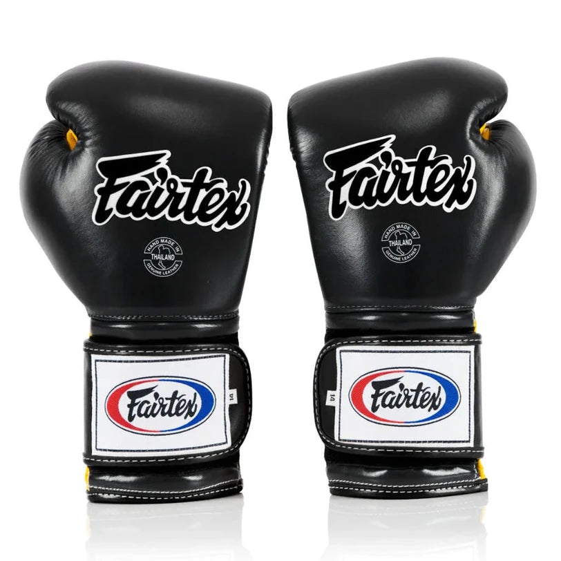 Pair of black Fairtex boxing gloves on a white background