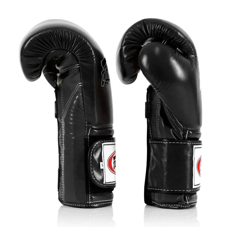 Pair of black boxing gloves with a brand logo on a white background