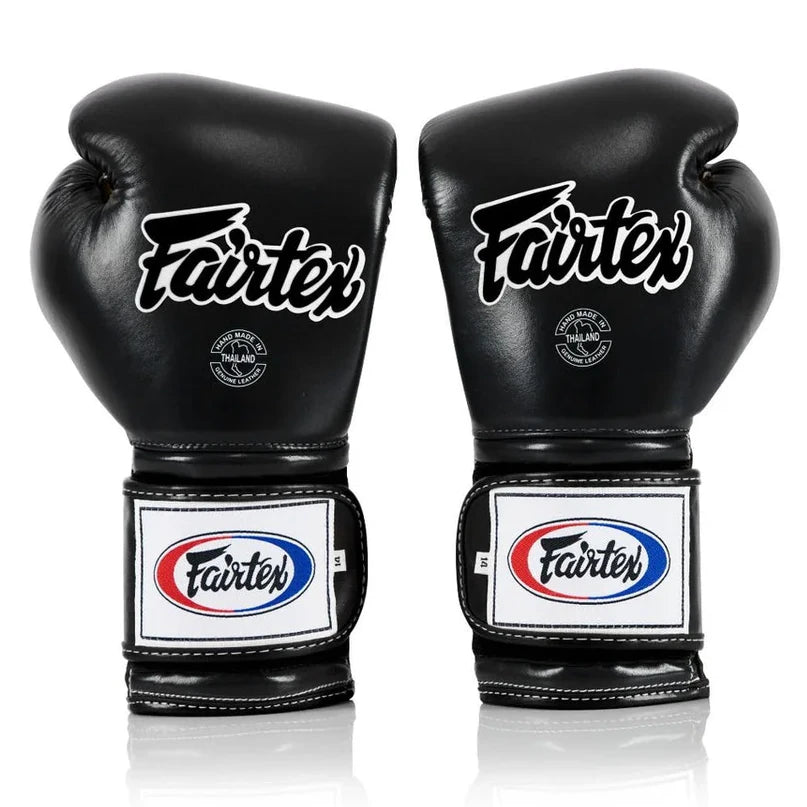 Pair of black Fairtex boxing gloves on a white background