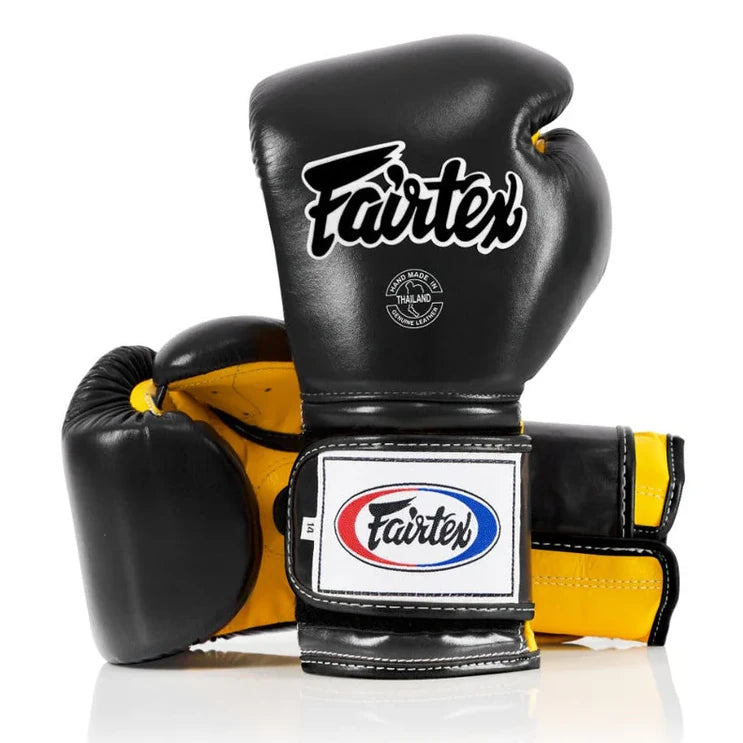 Black and yellow boxing gloves with Fairtex logo on a white background