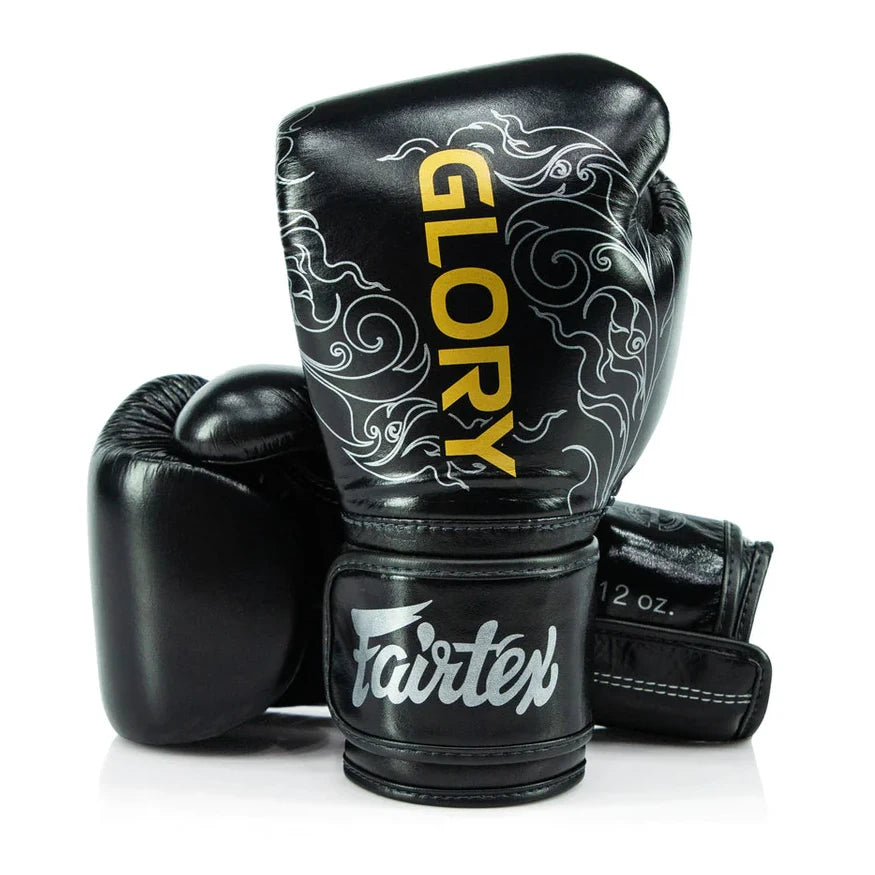 Black boxing gloves with 'Glory' and 'Fairtex' branding on a white background