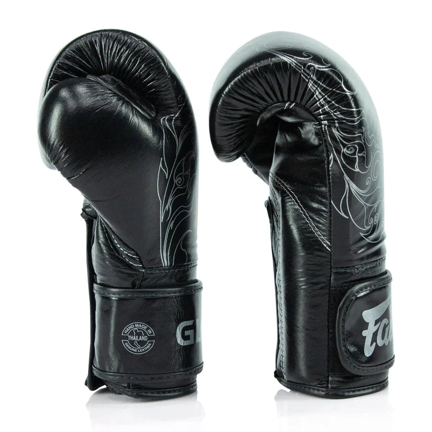 Black boxing gloves with white designs on a white background