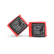 Red boxing hand wraps with black labels on a white background