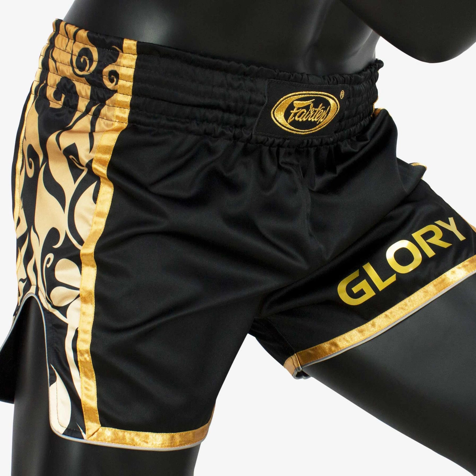 Black and gold Muay Thai shorts with 'GLORY' branding on a white background